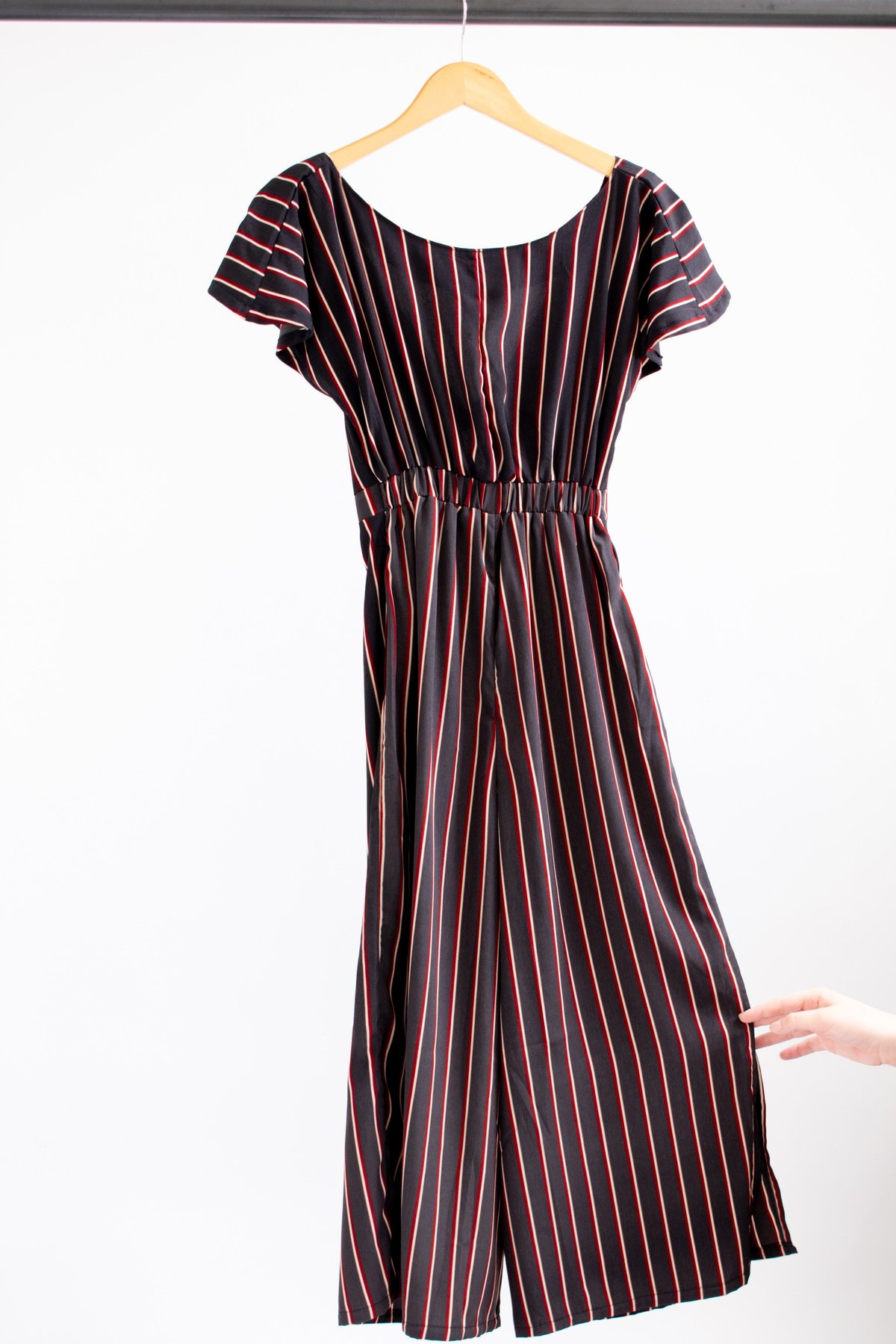 black jumpsuit with red stripe